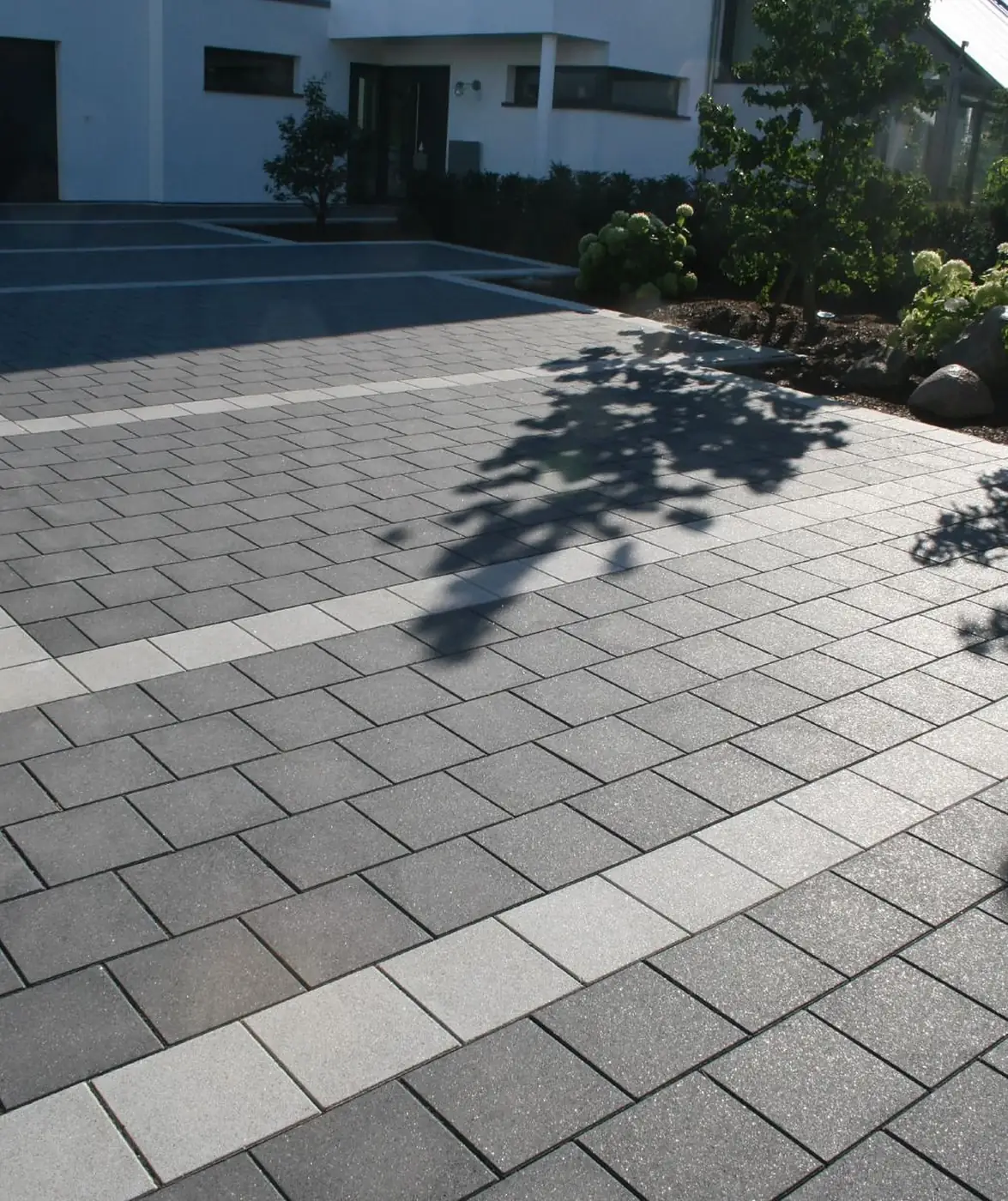 Driveway paved with grey pavers