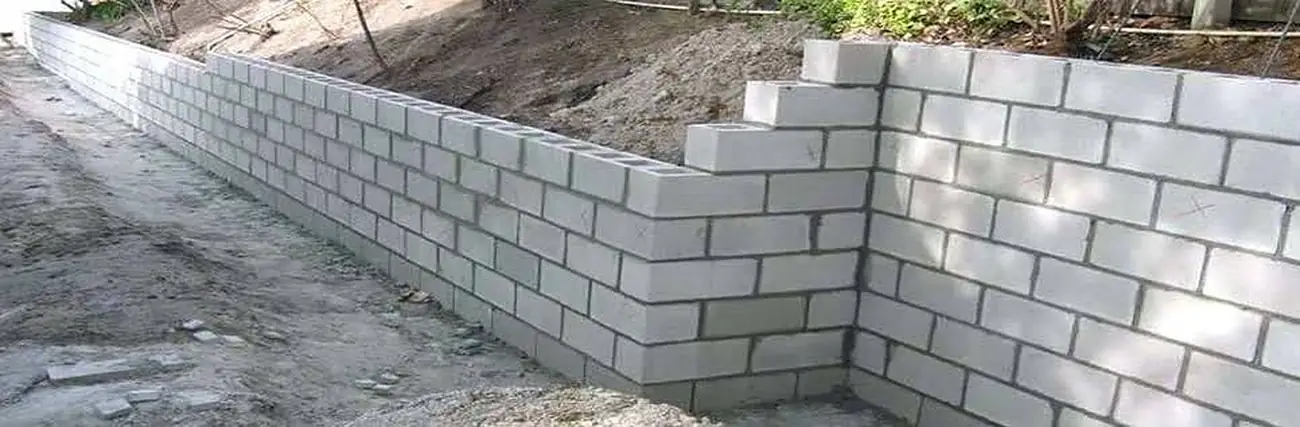 Long boundary wall in concrete blocks